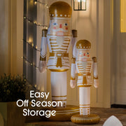 Inflatable nutcrackers with decorative lights and text 'Easy Off Season Storage' on a neutral background.